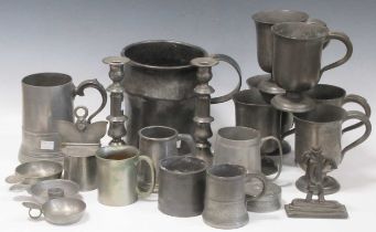A collection of various pewter items to include a pair of candlesticks, jugs, mugs etc