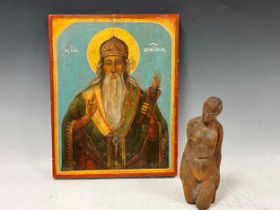 A late 19th or 20th century Greek painted wood icon, depicting St Spiridon, together with a carved