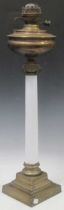 A white opalescent glass column oil lamp with stepped square brass base, 73cm high no shade of