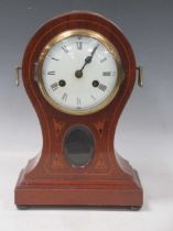An Edwardian inlaid mahogany balloon mantle clock with brass handles
