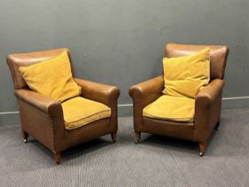 A near pair of early 20th century brown leather armchairs. 86cm x 79cm x 76cm