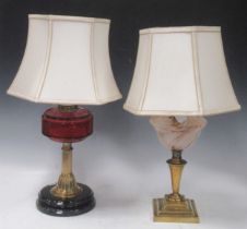 Two brass lamps one with ruby glass resovoir, the other with swirled glass. (2)