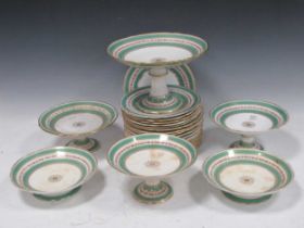 An English porcelain dessert service, the green ground border divided by a band of pink roses,