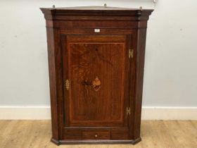 A large George III oak corner cupboard with shell inlay and drawer below 119 x 90cm