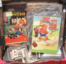 Two boxes of ephemera, to include childrens books and puzzles, loose cigarette cards, packets of