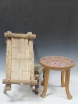 Three tribal stools, one with four legs and painted circular dished top, another triform with skin