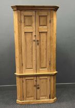 A George III style pine cupboard with fielded panel doors and cornice. 215cm x 98cm