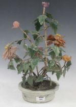 A Chinese hardstone model shrub or tree with colourful leaves, in an oval plant-holder shape base