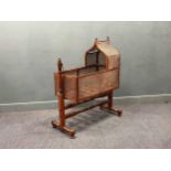 A Regency mahogany caned rocking cradle on stand. 125cm x 104cm x 46cm