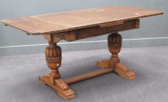 A late 19th century oak draw leaf extending table with heavily carved bulbous leg and gadrooned