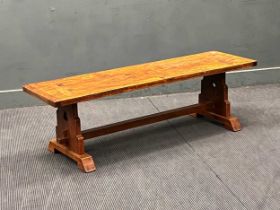 A 20th century oak bench with deep seat with pierced trefoil end supports. 46cm x 152cm x 45cm (