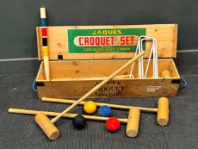 A modern croquet set by Jacques, comprising four mallets, four balls, six hoops, a pin, in a pine
