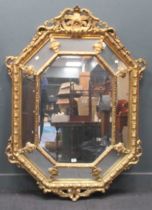 A modern octagonal cushion moulded gilded composite wall mirror, surmounted by scrolling acanthus