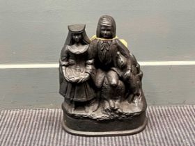 A cast iron black painted doorstop of a man and woman with dog 31 x 25 x 8.5cm