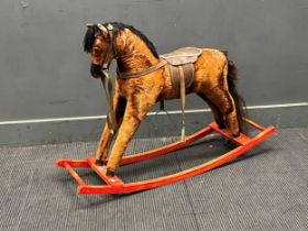 A small plush covered rocking horse 77 x 106 x 31cm
