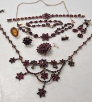 A collection of garnet set jewellery with base metal settings together with a garnet set ring and