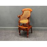 A 19th century mahogany child's caned bergere chair on stand. 98cm x 46cm x 48cm