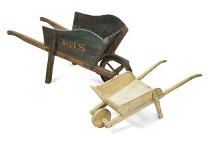 Two decorative painted wheelbarrows or hand carts,