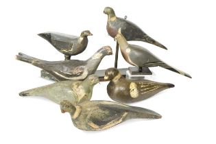 A collection of seven decoy pigeons,