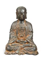 A Chinese cast iron seated meditating Lohan Ksitigarbha, probably 17th century,