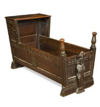 An oak panelled cradle in 17th century style,