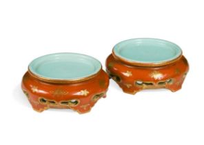 A pair of Chinese coral glazed and gilded porcelain vase stands, possibly mark and Period of the Qi
