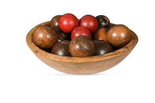 A collection of lignum lawn bowls,
