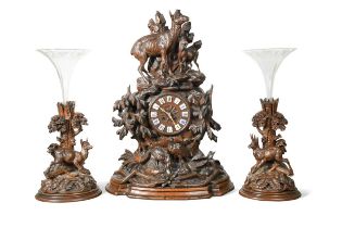 A carved Black Forest clock garniture, 19th century,