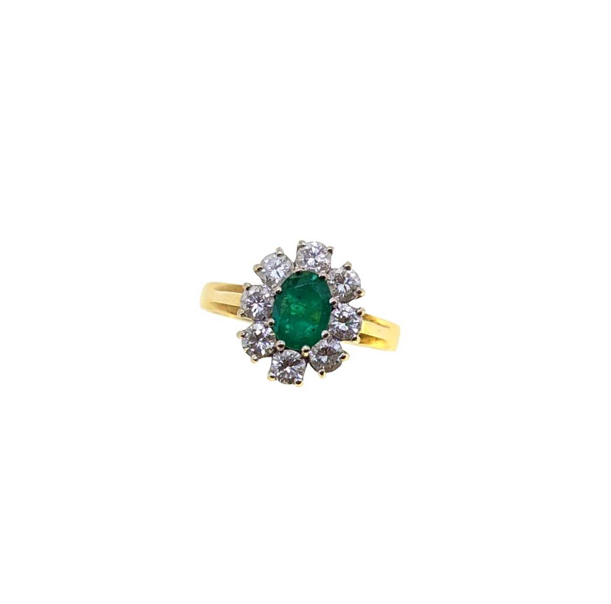 An 18ct gold emerald and diamond cluster ring,