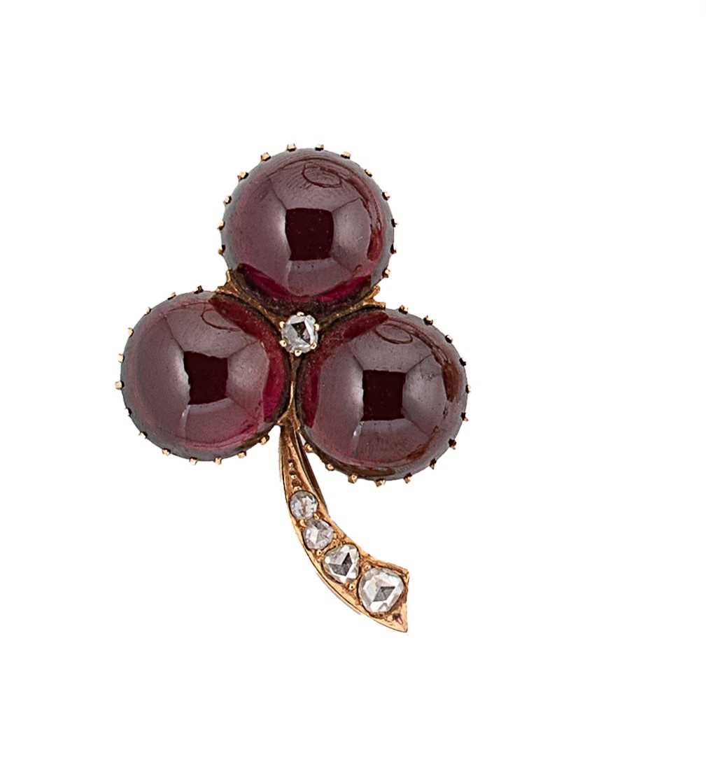 A garnet and diamond brooch,