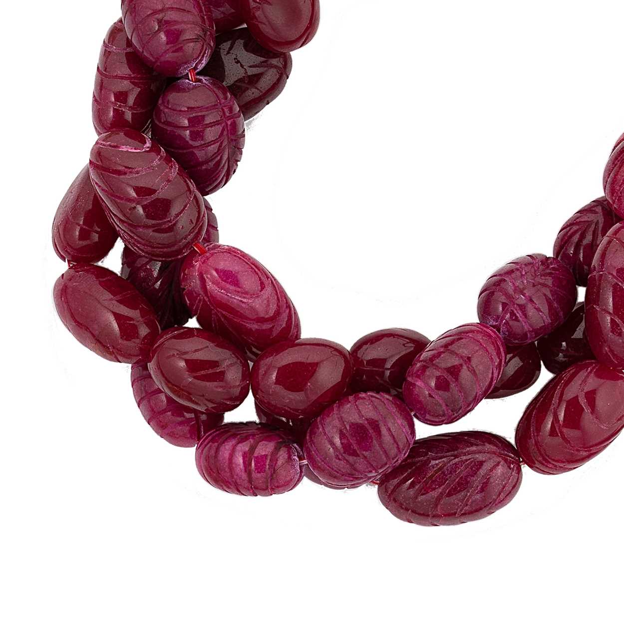 A carved ruby bead necklace,