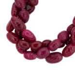 A carved ruby bead necklace,