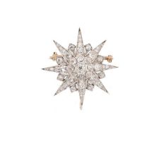 A diamond set star brooch,