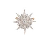 A diamond set star brooch,