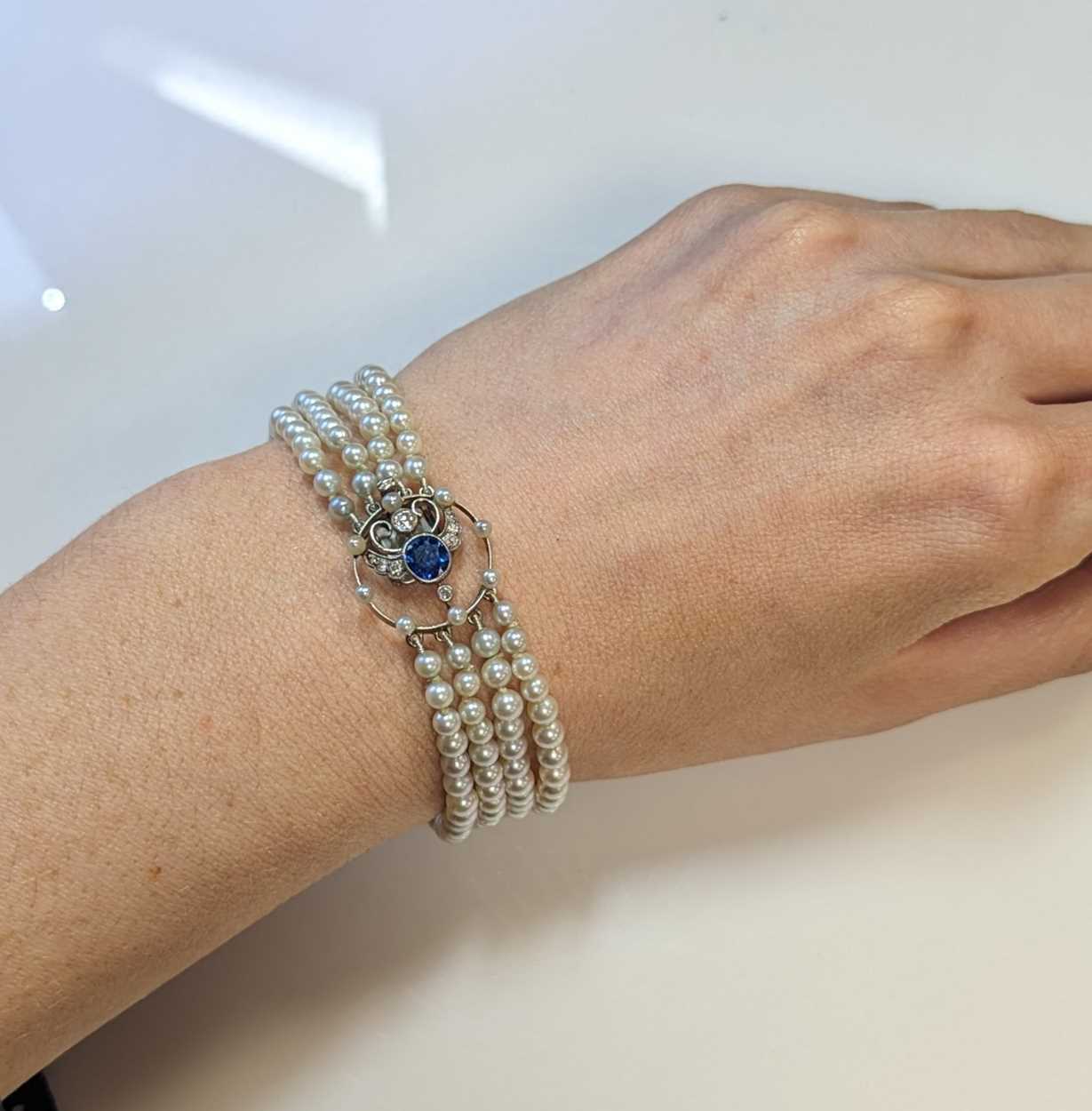 A four row pearl bracelet with a sapphire and diamond clasp, - Image 4 of 4