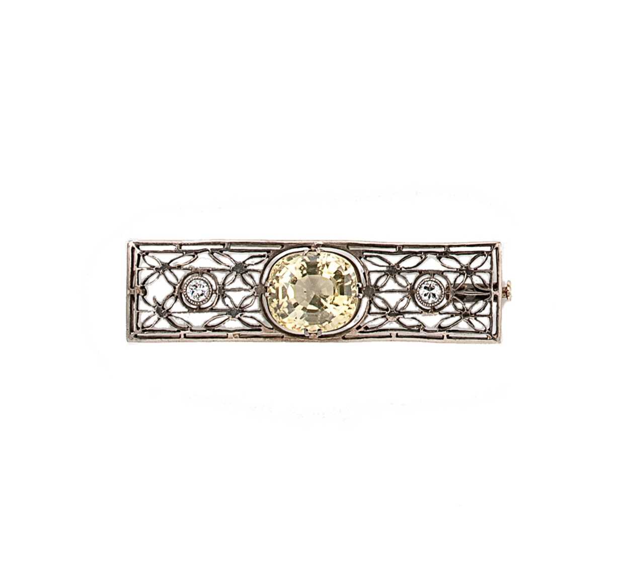 An early 20th century yellow sapphire and diamond set brooch,