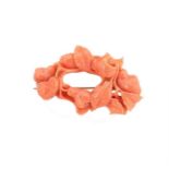 A carved coral brooch,