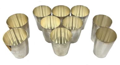 A set of six German metalwares silver stacking shot cups together with a further two pairs,