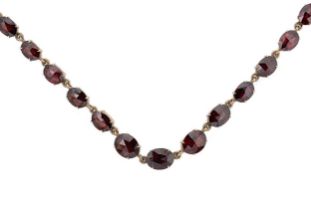 A Victorian garnet rivière style necklace,