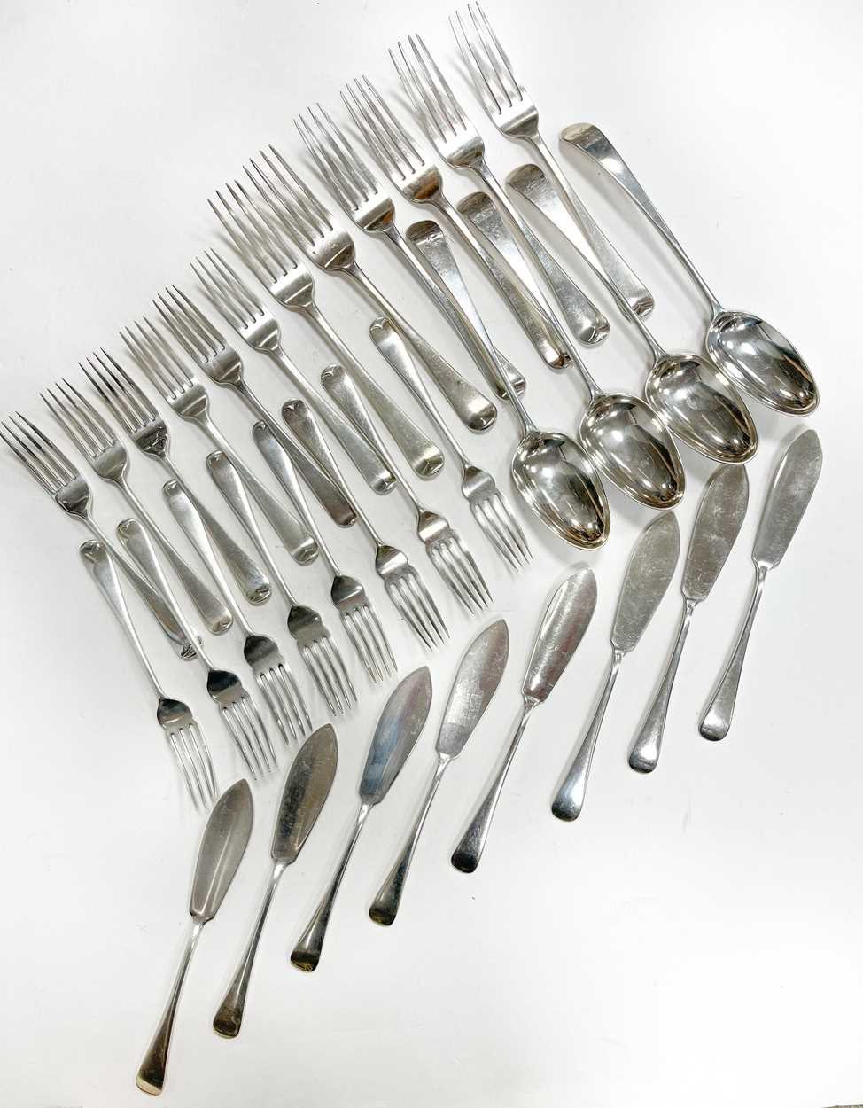 A 32-piece harlequin set of George III and later silver cutlery and flatware,
