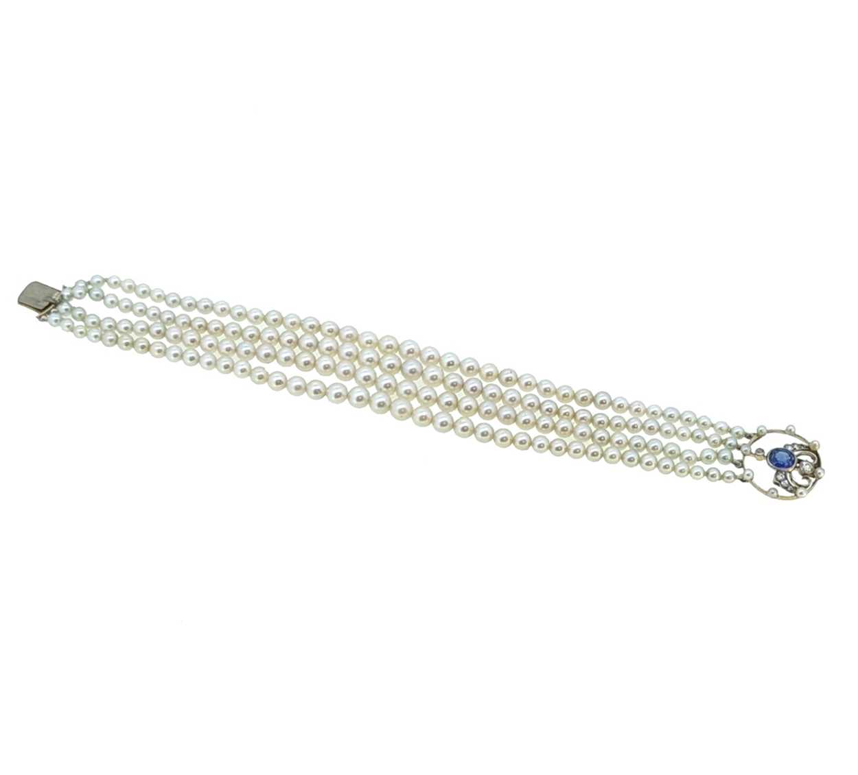 A four row pearl bracelet with a sapphire and diamond clasp,