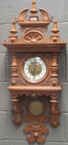 A carved oak wall clock circa 1900, 105cm high