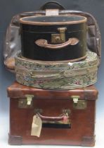 A large square leather suitcase by H J Cave and Sons "Osilite", monogrammed MC No 3, a black and tan