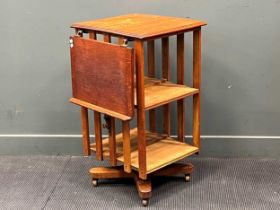 An early 20th century oak revolving bookcase, with an adjustable book rest, on castors 91 x 54 x