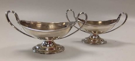 A pair of silver boat shaped two handled salts, early 20th century, 153g, (4.9ozt) gross (2)