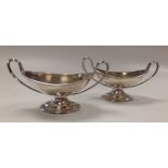 A pair of silver boat shaped two handled salts, early 20th century, 153g, (4.9ozt) gross (2)