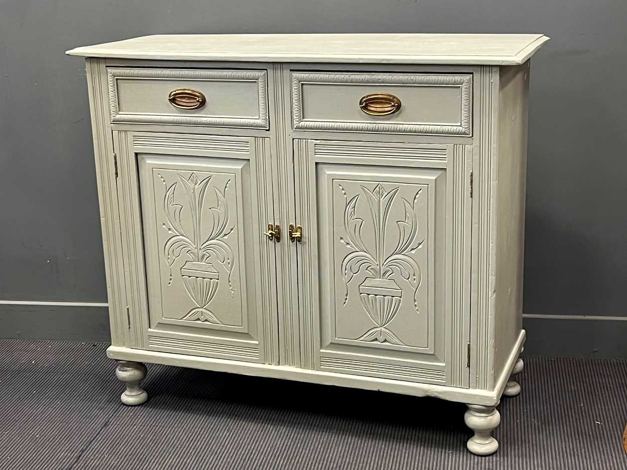 A painted pine side cabinet, with two frieze drawers over a pair of cupboard doors on turned feet