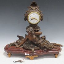 Circa 1900, a French painted metal figural mantel clock, the central female figure flanked by