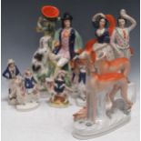 A collection of Staffordshire figures including a pair of greyhounds; a spill vase entitled Dog Tray