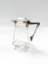 A small silver rmounted glass jug and a silver sauceboat (2) 13.5cms high for the glass jug  sauce